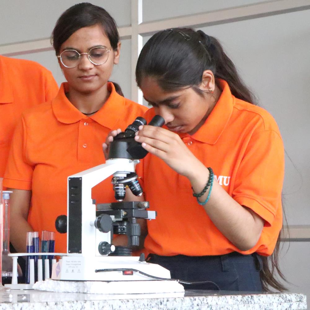 Baba Mastnath university Students with microscope